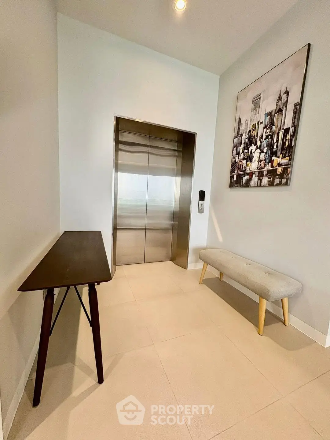 Modern elevator lobby with stylish decor and cityscape artwork