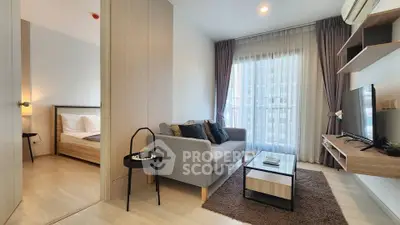 Modern living room with cozy sofa, TV, and natural light from large window in stylish apartment.