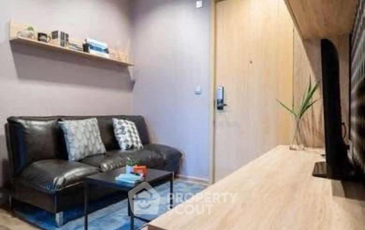 Cozy living room with modern decor and sleek black sofa