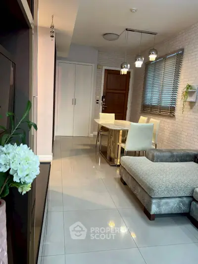 Modern living room with stylish decor, cozy sofa, and elegant dining area.