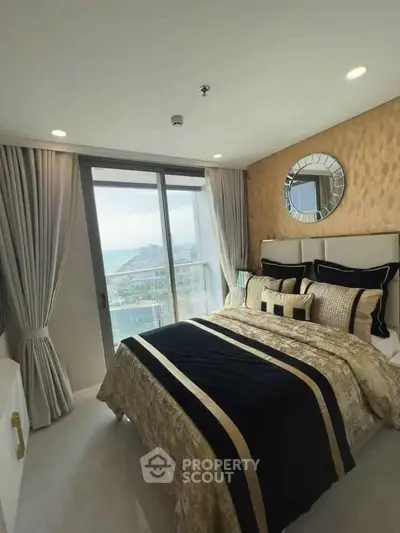 Luxurious bedroom with elegant decor and stunning city view from large window.