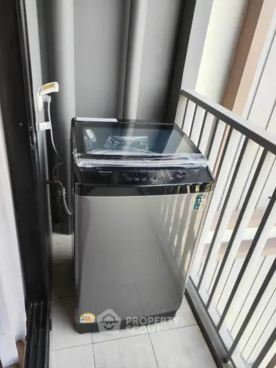 Modern washing machine on a compact balcony in urban apartment