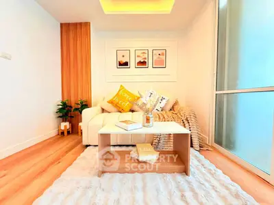 Cozy living room with modern decor and warm lighting, perfect for relaxation.