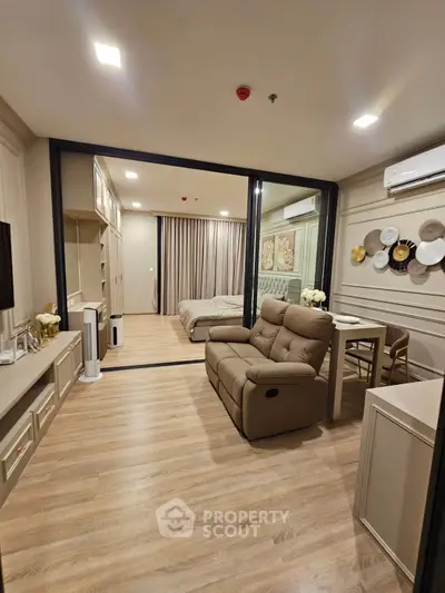 Modern living room with elegant decor and cozy seating in a stylish apartment.