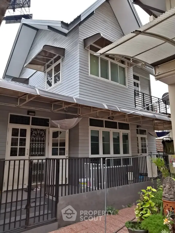 Charming two-story house with modern exterior and spacious balcony, perfect for family living.