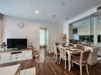 Elegant living and dining area with modern decor and wooden flooring