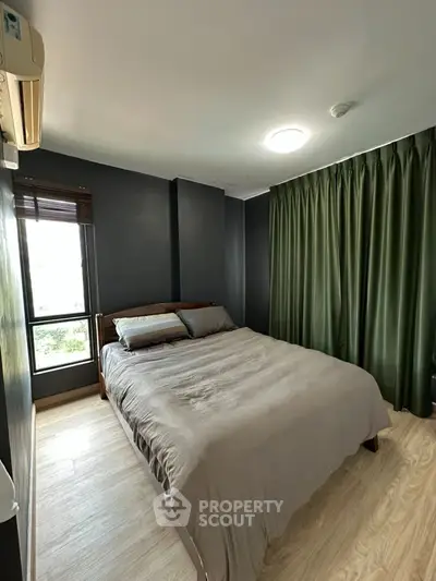 Cozy bedroom with modern decor and large window for natural light