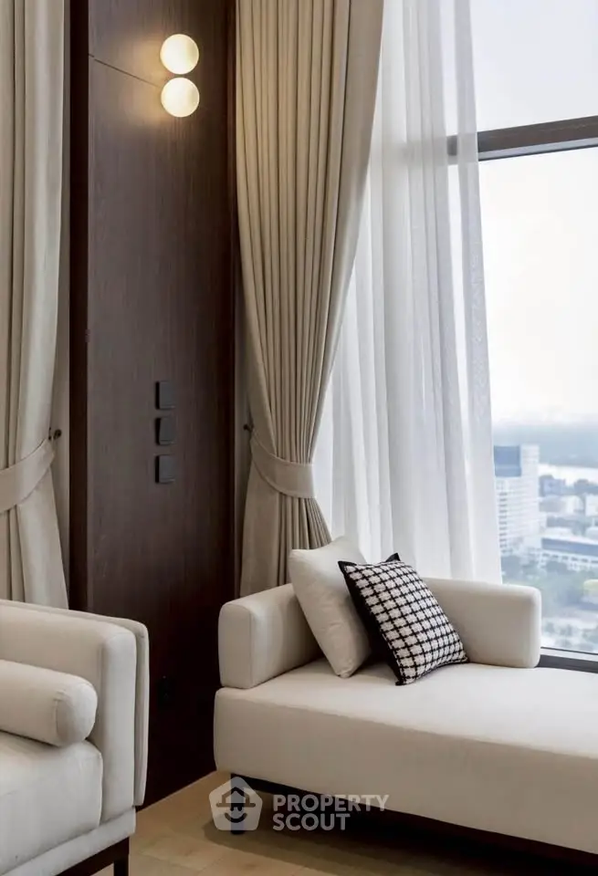Luxurious living room with elegant curtains and modern furniture, offering a stunning city view.