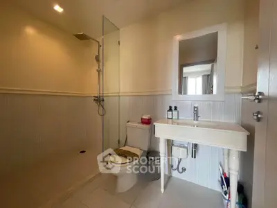 Modern bathroom with walk-in shower and elegant vanity in a stylish home.
