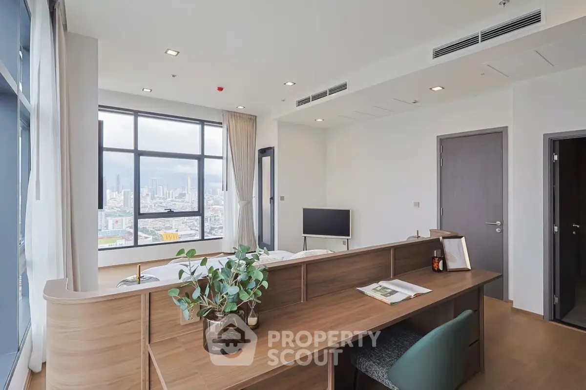 Modern living room with city view, stylish decor, and ample natural light.