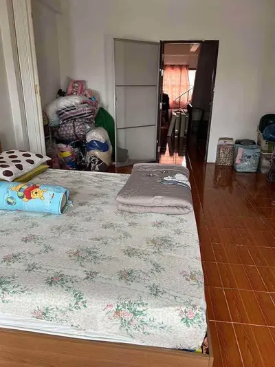 Cozy bedroom with floral bedding and ample storage space, perfect for comfortable living.