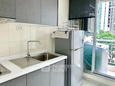 Modern kitchen with sleek cabinets and balcony view