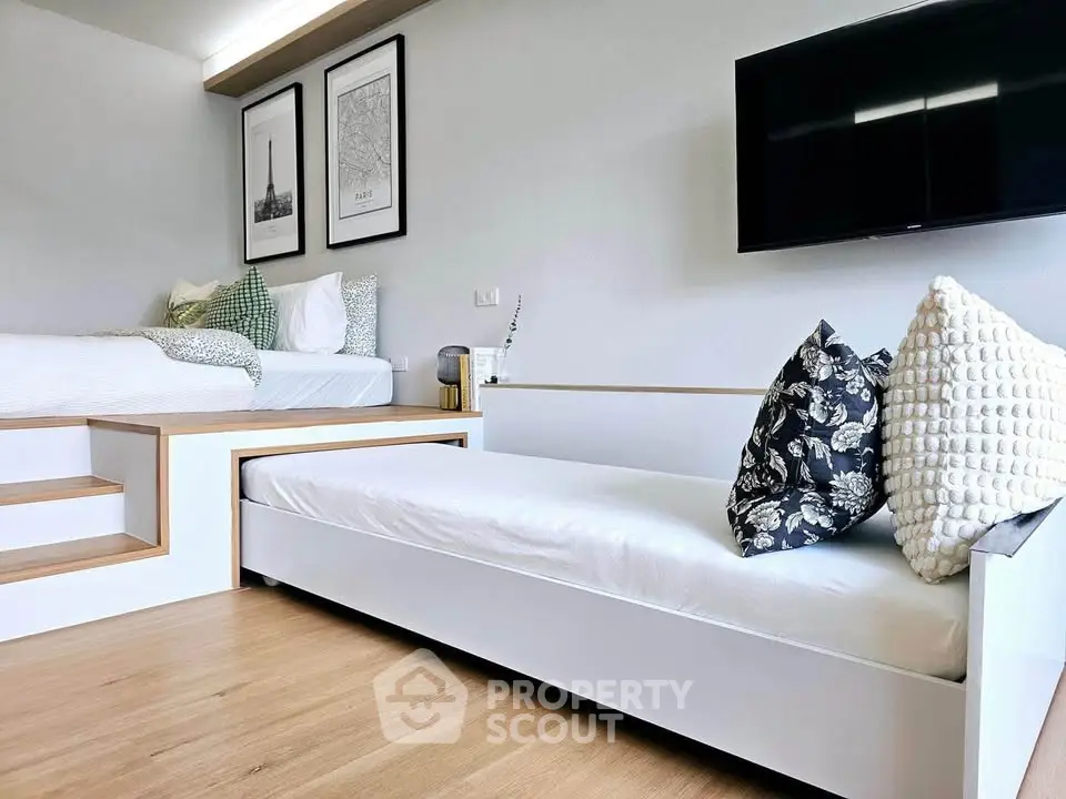 Modern bedroom with sleek design, featuring a stylish bed and cozy seating area, perfect for relaxation.