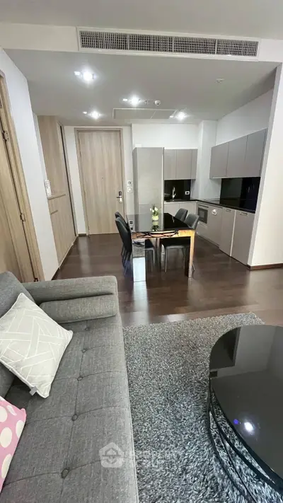 Modern open-plan living room with sleek kitchen and stylish furniture