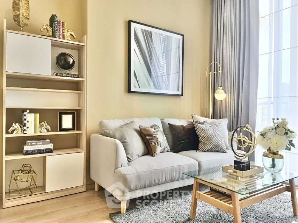 Stylish modern living room with cozy sofa, elegant decor, and large window for natural light.