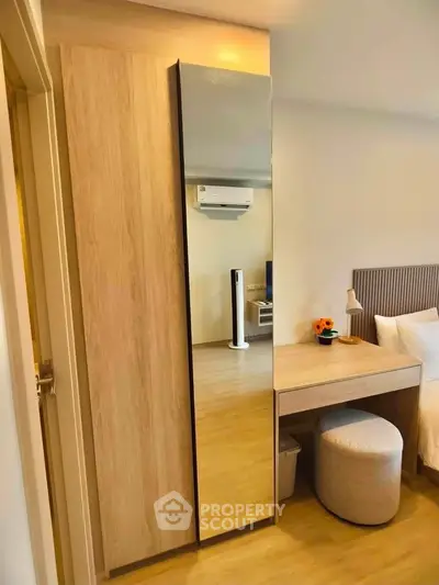 Modern bedroom with mirrored wardrobe and cozy decor