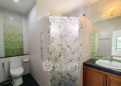Modern bathroom with floral shower curtain and stylish sink area