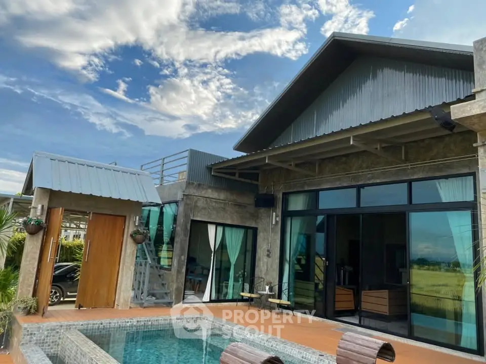 Modern villa with private pool and rooftop terrace under a clear blue sky.