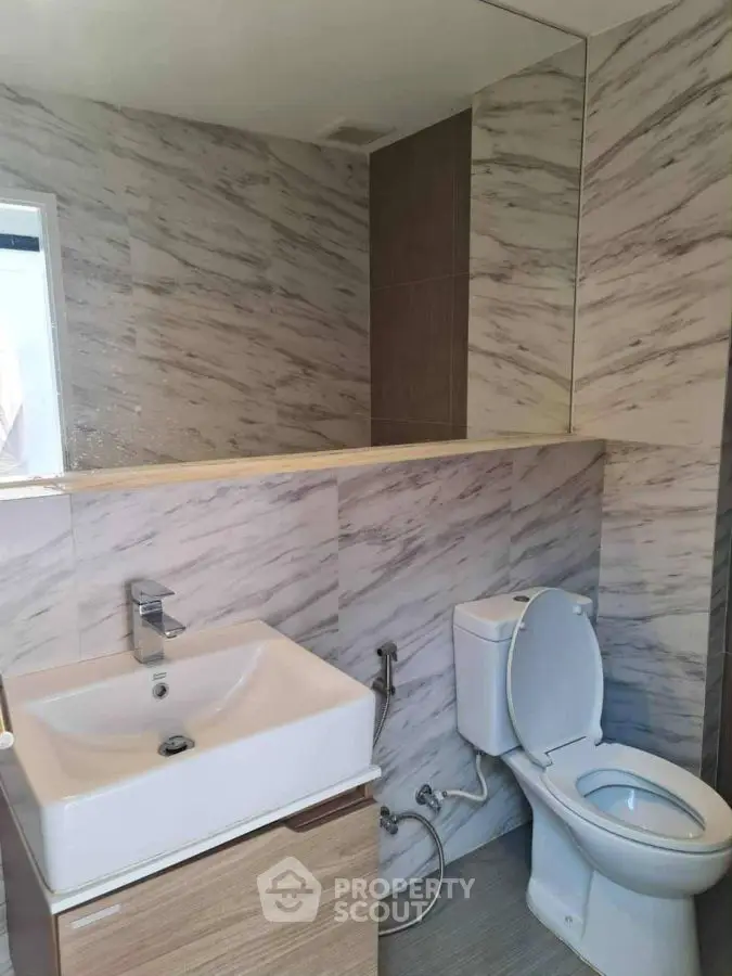 Modern bathroom with marble tiles and sleek fixtures