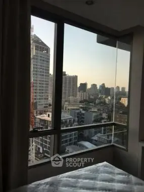 Stunning city view from a modern high-rise apartment bedroom window.