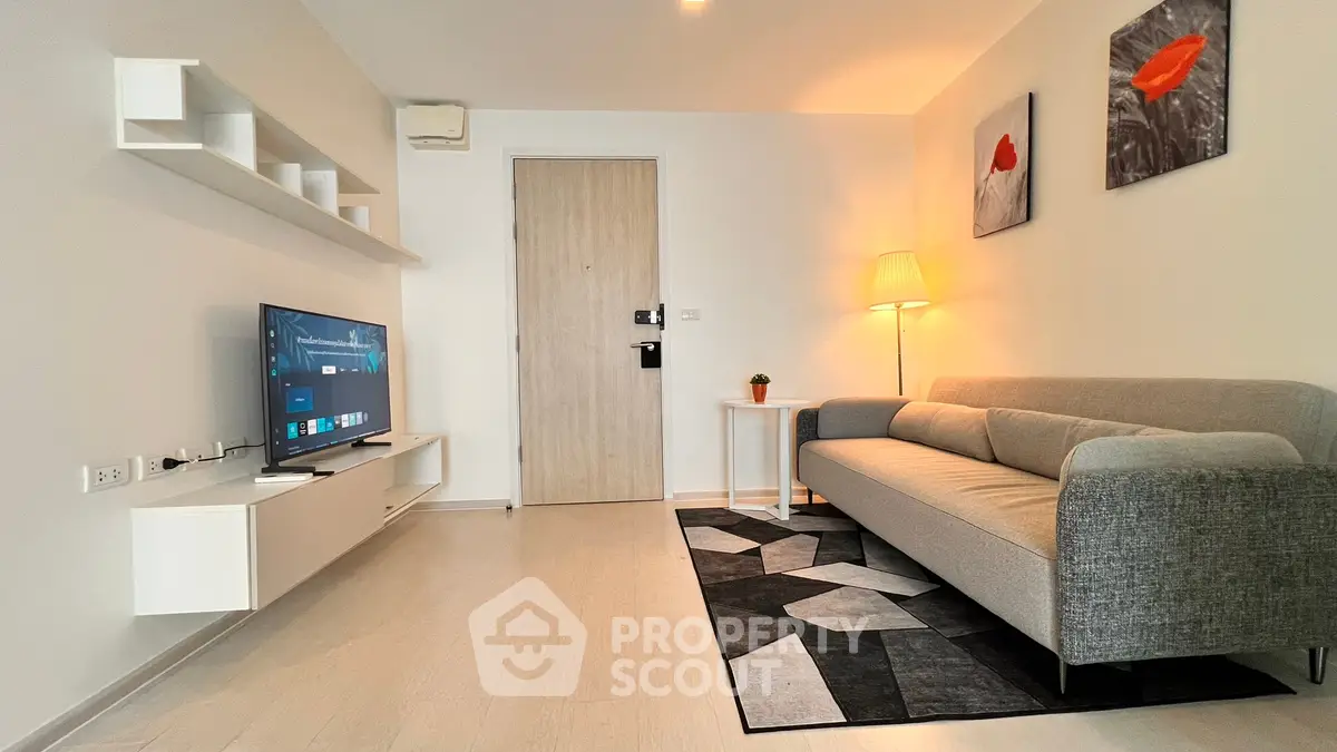 Modern living room with sleek furniture and wall-mounted TV, perfect for contemporary living.