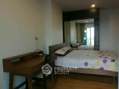 Cozy bedroom with wooden furniture and large mirror wardrobe