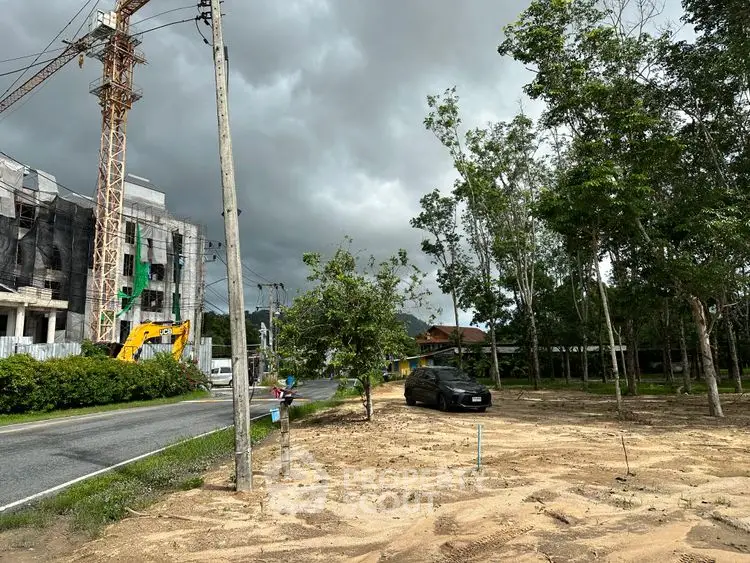 Vacant land with construction site and trees, ideal for development opportunities.
