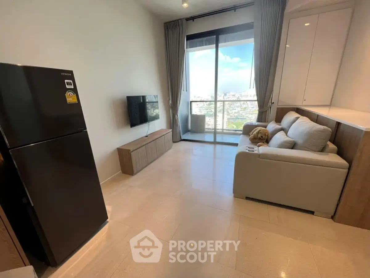 Modern living room with city view, featuring sleek furniture and large windows for natural light.