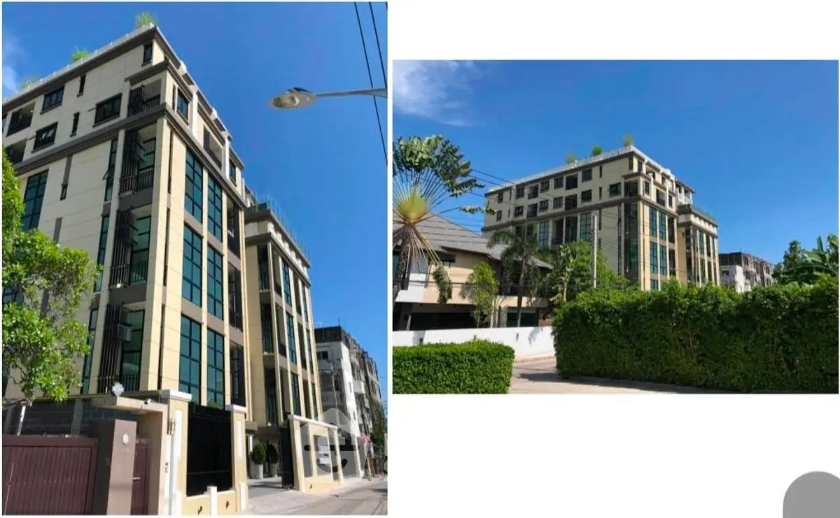 Modern multi-story building with lush greenery and clear blue sky.