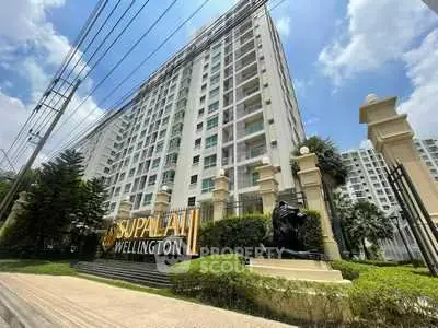 Stunning view of Supalai Wellington condominium exterior with lush greenery and clear blue sky.