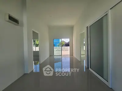 Spacious modern interior with sleek tile flooring and sliding glass doors