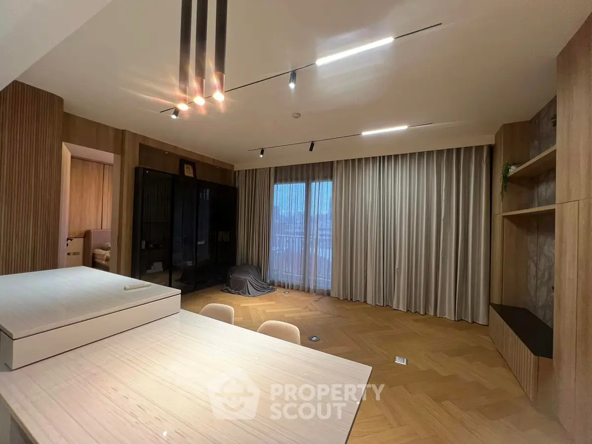 Spacious modern living room with elegant wooden flooring and stylish lighting