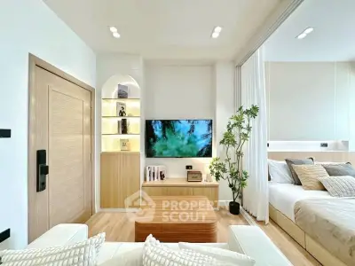 Modern living room with stylish decor and integrated bedroom area