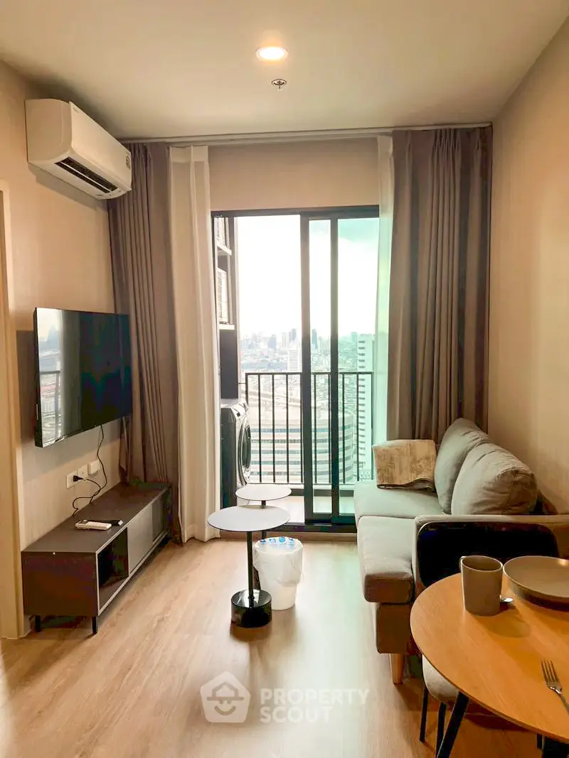 Modern living room with city view, featuring cozy sofa and wall-mounted TV.