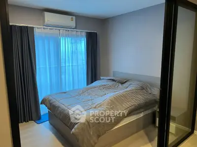 Cozy bedroom with modern decor and large window for natural light