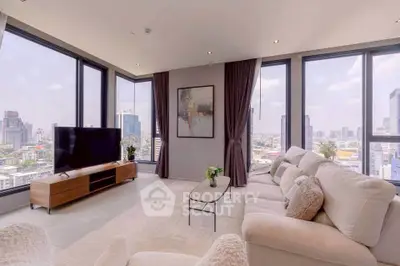 Luxurious corner unit living room with panoramic city views and modern decor.