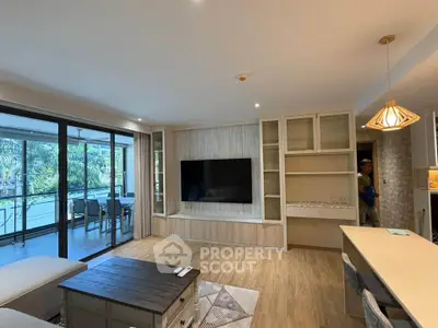 Spacious modern living room with large TV and balcony view