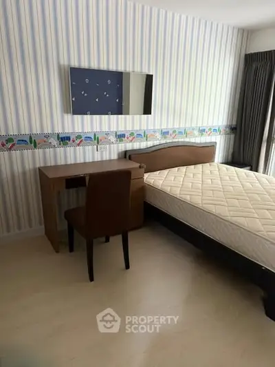 Cozy bedroom with stylish wallpaper and comfortable furniture