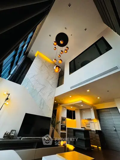 Luxurious modern living room with high ceiling and elegant lighting in a stylish apartment.