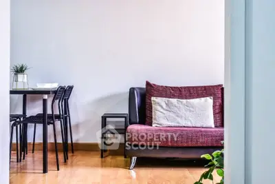 Modern living room with stylish sofa and dining area, perfect for cozy urban living.
