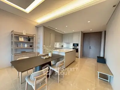 Modern kitchen with sleek design and open layout, featuring dining area and stylish decor.