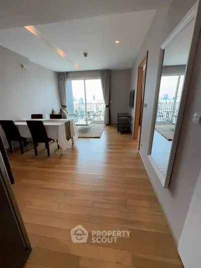Spacious modern living room with city view and elegant wooden flooring
