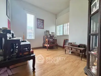 Charming study room with wooden flooring and ample natural light, perfect for a serene workspace.