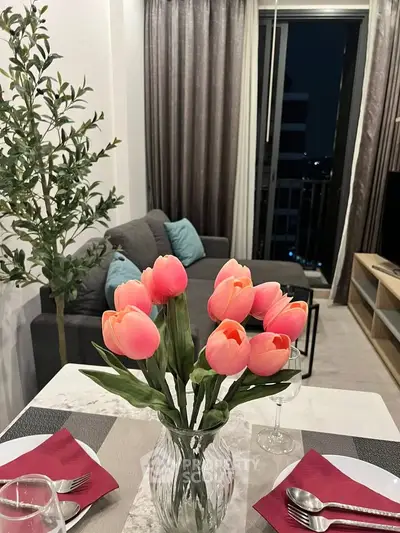 Chic modern living room with elegant decor and balcony view, perfect for urban living.