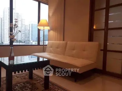 Cozy living room with city view, modern sofa, and elegant decor.