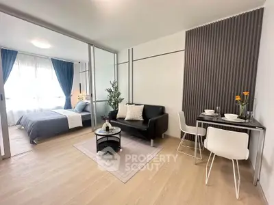 Modern studio apartment with open layout, featuring cozy living area and stylish dining space.