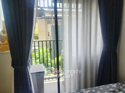 Cozy bedroom with balcony view and elegant curtains in modern apartment.