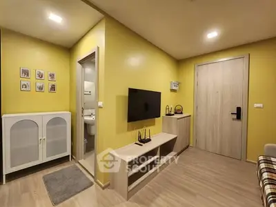 Modern living room with yellow walls, TV, and stylish wooden furniture