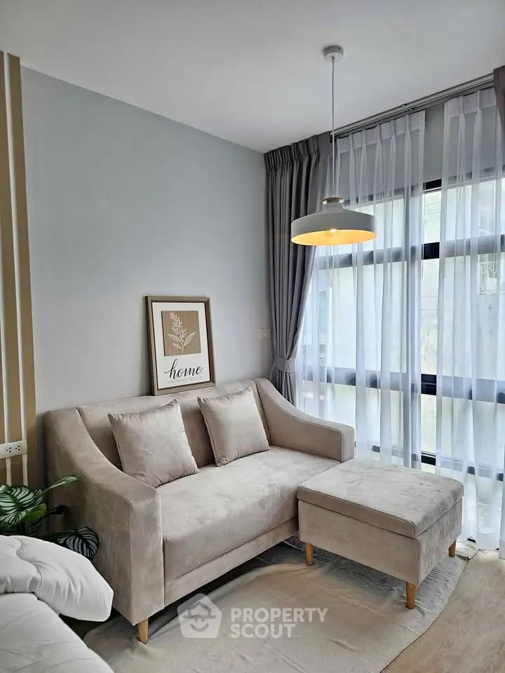 Stylish living room with modern sofa and large window, perfect for relaxation.