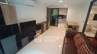 Modern living room with sleek furniture and open kitchen layout, perfect for contemporary living.